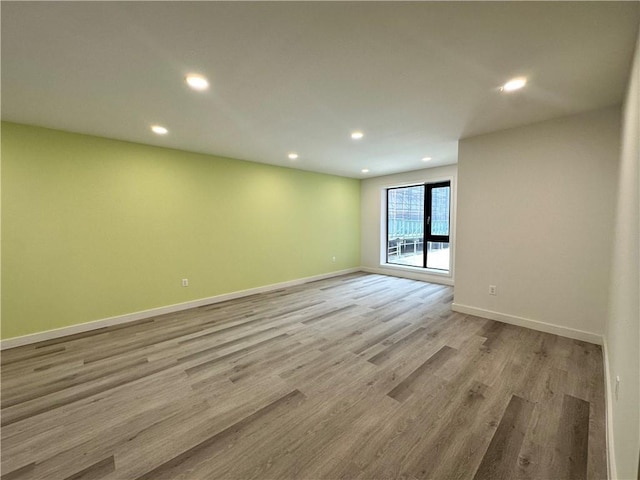 unfurnished room with light wood-type flooring