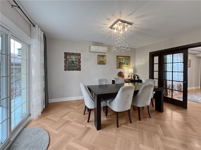 dining space with an inviting chandelier, a wall mounted air conditioner, a wealth of natural light, and light parquet floors