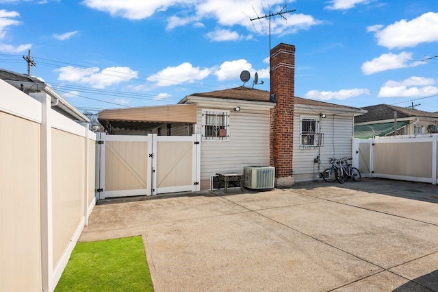 rear view of house with a patio area and central air condition unit