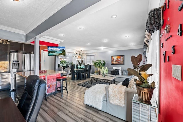 living room featuring crown molding, a textured ceiling, and light hardwood / wood-style floors