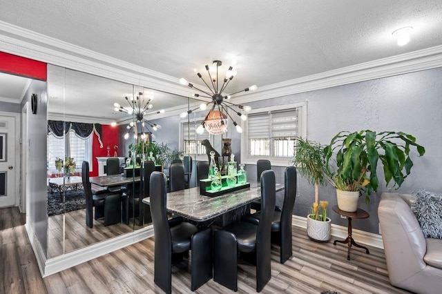 dining room with hardwood / wood-style floors, crown molding, and plenty of natural light