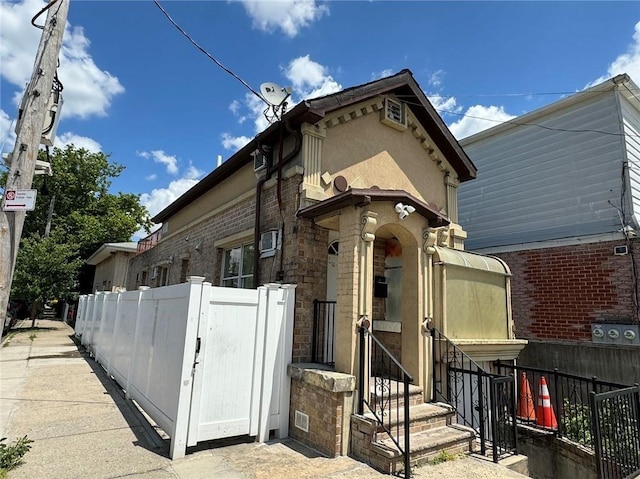 view of front of home featuring fence and stucco siding