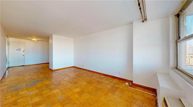 spare room featuring baseboards and baseboard heating