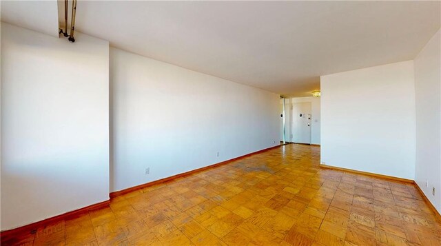 spare room with light parquet flooring