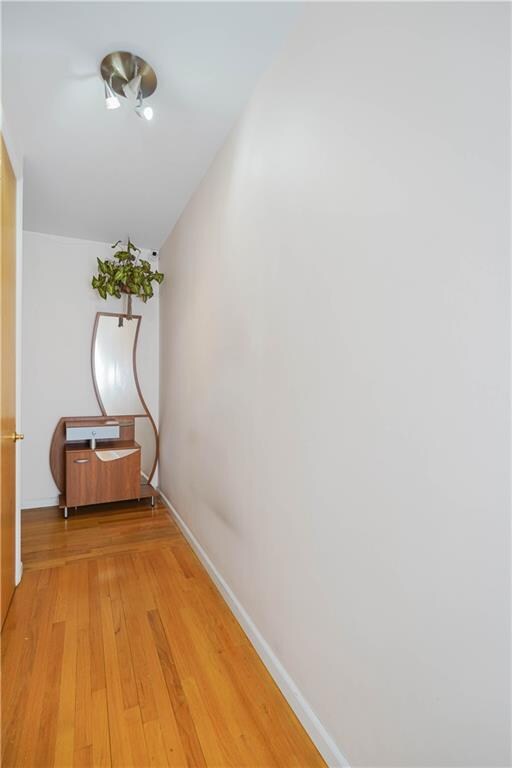 corridor with light hardwood / wood-style floors