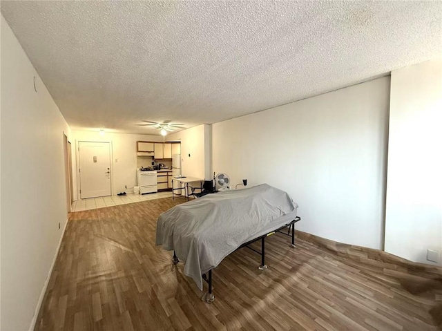 bedroom featuring a textured ceiling and light hardwood / wood-style flooring