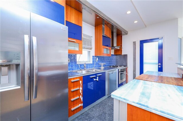 kitchen featuring appliances with stainless steel finishes, sink, and backsplash