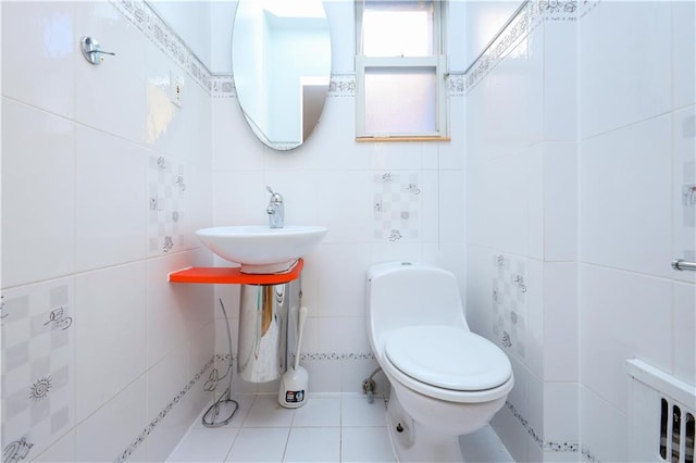 bathroom featuring sink, tile walls, tile patterned floors, and toilet