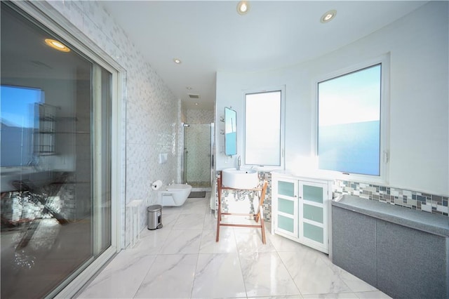 bathroom featuring marble finish floor, tile walls, a bidet, a shower stall, and vanity