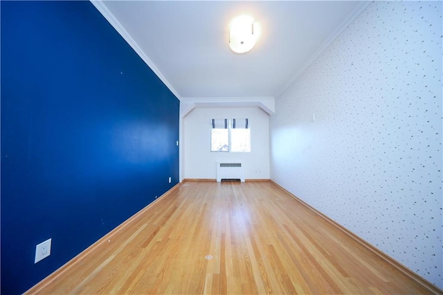 additional living space featuring radiator and wood finished floors