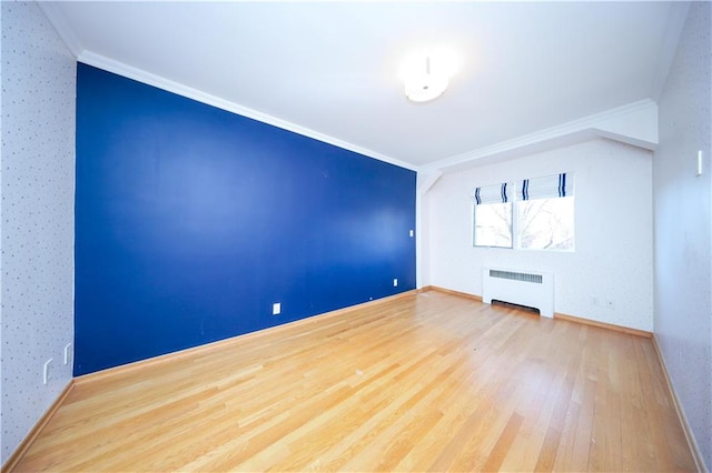 bonus room featuring wood-type flooring and radiator