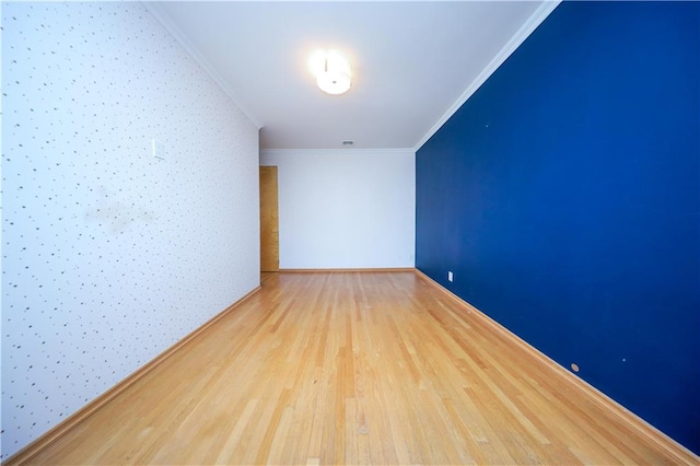 unfurnished room with wood finished floors and crown molding