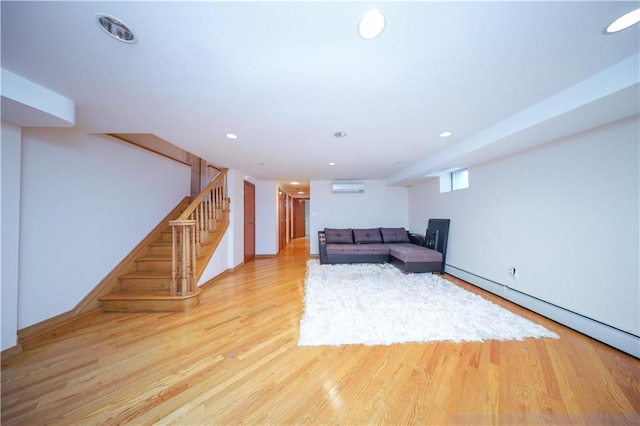 unfurnished living room featuring light wood-style flooring, recessed lighting, a baseboard heating unit, stairs, and a wall mounted AC