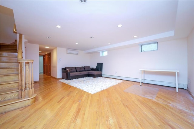 unfurnished living room featuring recessed lighting, stairway, an AC wall unit, and wood finished floors