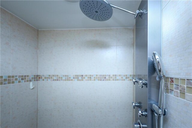 bathroom with a tile shower