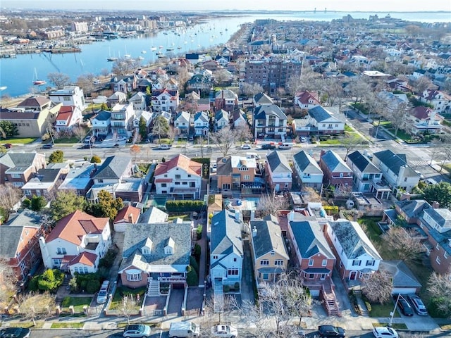 drone / aerial view featuring a water view and a residential view