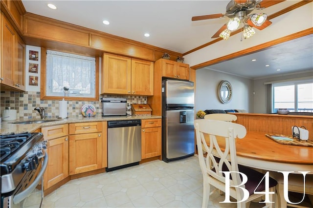 kitchen featuring sink, crown molding, tasteful backsplash, stainless steel appliances, and light stone countertops