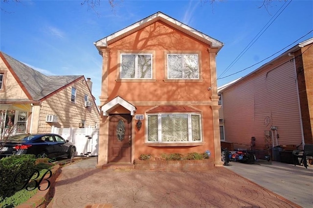 view of front of home with fence and stucco siding