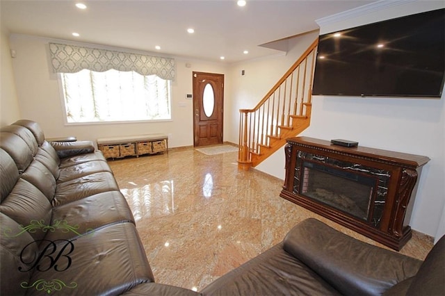 living area featuring recessed lighting, marble finish floor, crown molding, and stairs