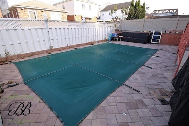 view of pool featuring a patio area and a fenced backyard