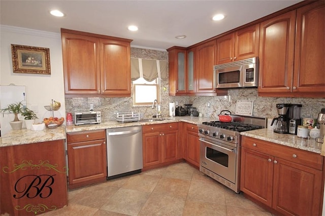 kitchen featuring light stone counters, stainless steel appliances, decorative backsplash, brown cabinetry, and ornamental molding