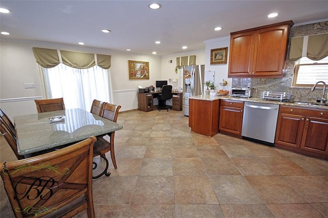 kitchen featuring a sink, light stone countertops, stainless steel appliances, backsplash, and recessed lighting