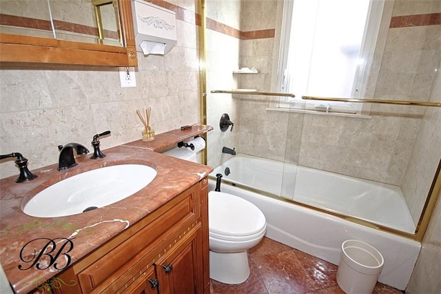 bathroom with enclosed tub / shower combo, toilet, vanity, tile walls, and decorative backsplash