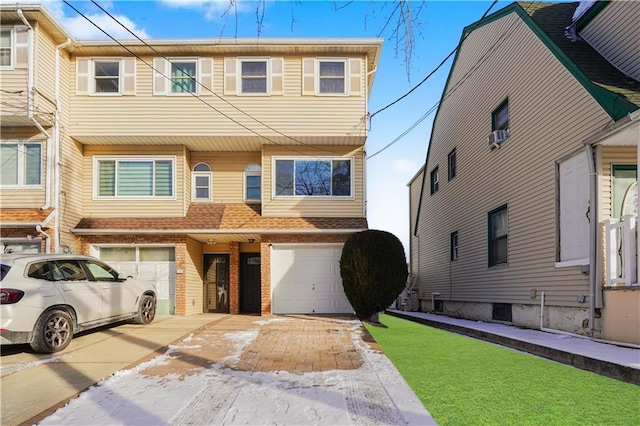 townhome / multi-family property featuring a garage and a front yard