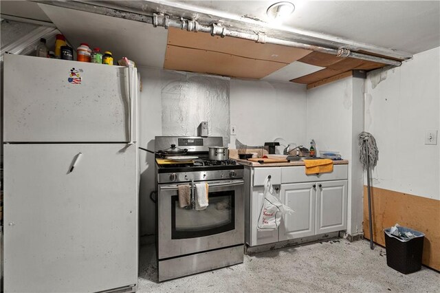 kitchen with gas stove and white refrigerator