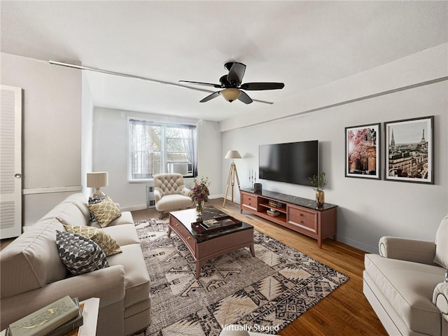 living room featuring wood-type flooring, cooling unit, and ceiling fan