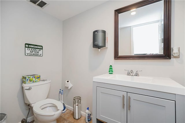 bathroom featuring vanity, tile patterned floors, and toilet