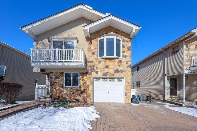 view of front of property with a balcony and a garage