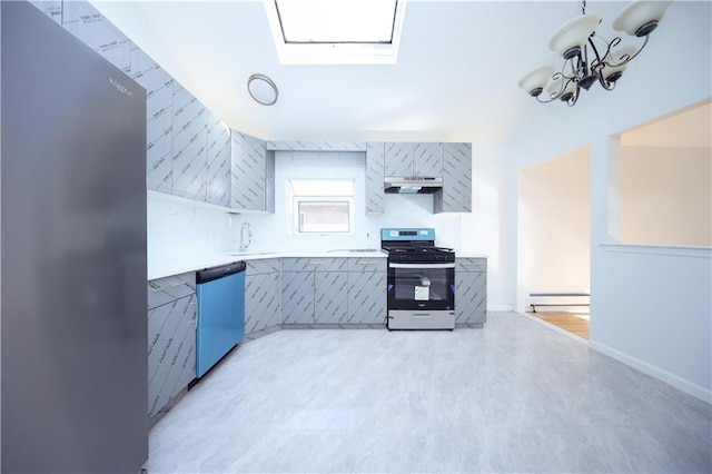 kitchen featuring sink, baseboard heating, appliances with stainless steel finishes, a skylight, and a chandelier