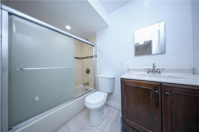 full bathroom with vanity, combined bath / shower with glass door, tile patterned floors, and toilet