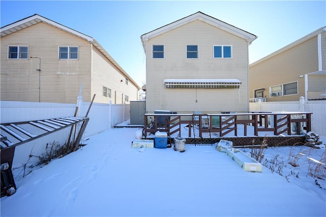 snow covered property featuring a wooden deck