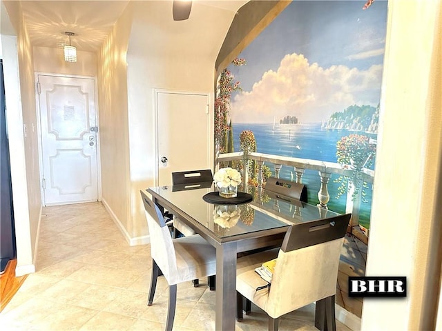 tiled dining room with lofted ceiling