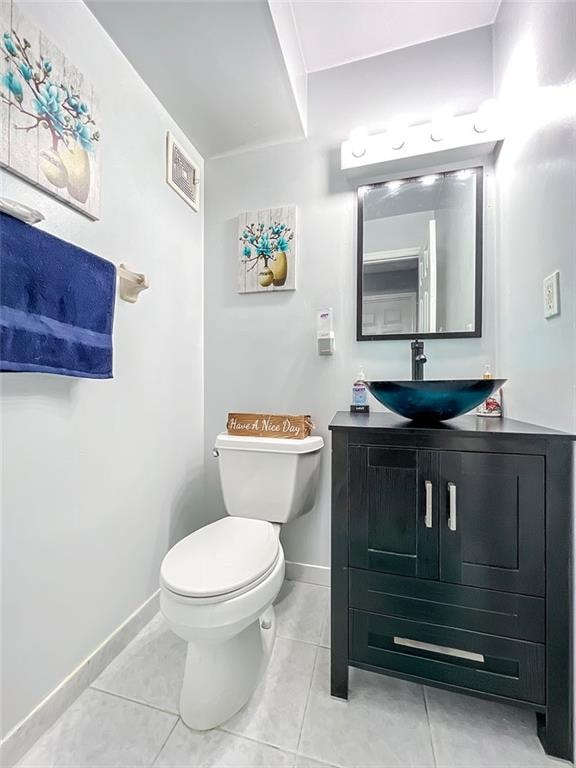 bathroom with tile patterned flooring, visible vents, vanity, and toilet