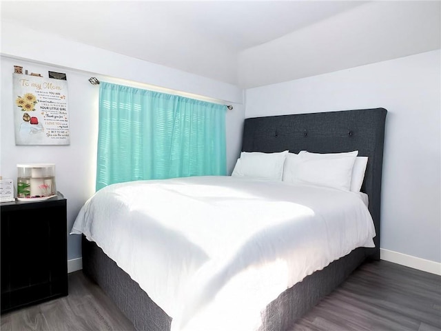 bedroom featuring baseboards and wood finished floors