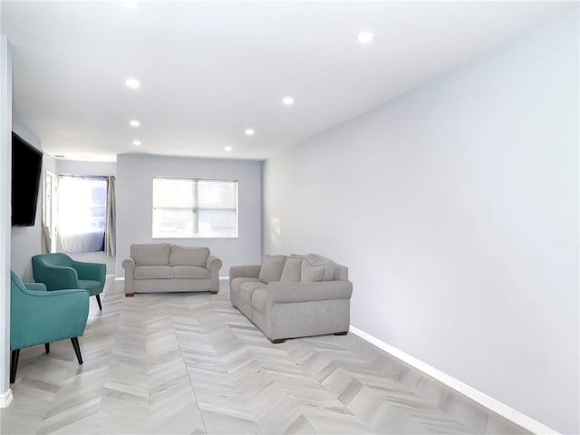 living room featuring baseboards and recessed lighting