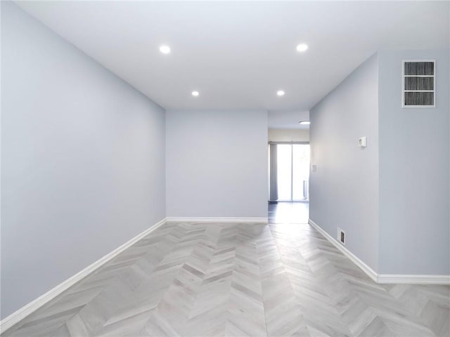 empty room with recessed lighting, visible vents, and baseboards