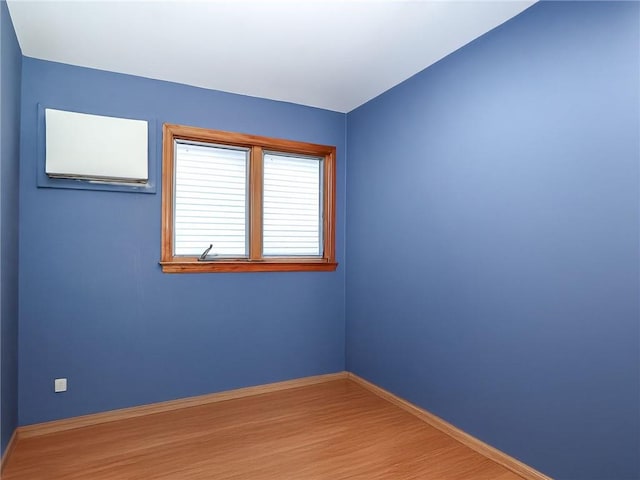 unfurnished room featuring baseboards and wood finished floors