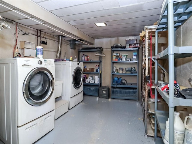 laundry area featuring washing machine and clothes dryer and laundry area