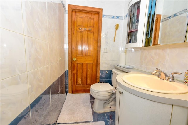 bathroom with tile walls, vanity, decorative backsplash, and toilet