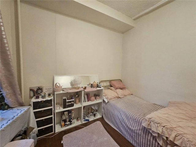 bedroom with dark wood finished floors