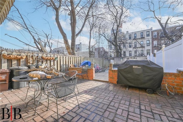 view of patio / terrace featuring fence, grilling area, and outdoor dining space