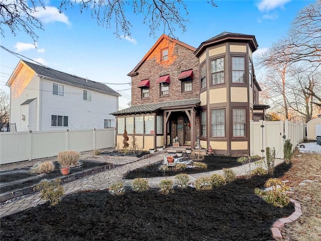 rear view of property with fence