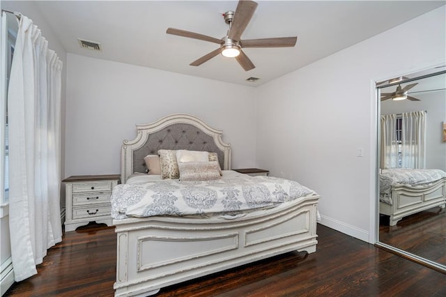 bedroom featuring visible vents, baseboards, wood finished floors, and a baseboard radiator