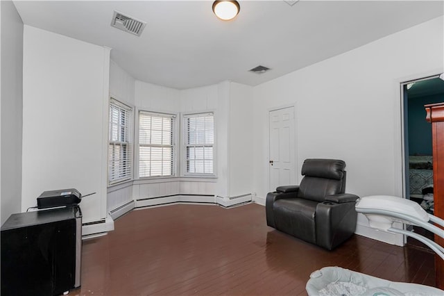 sitting room with visible vents and wood finished floors