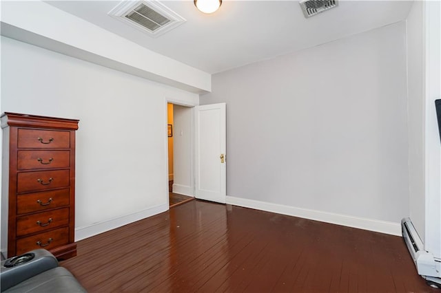 interior space featuring baseboards, visible vents, and dark wood-style flooring