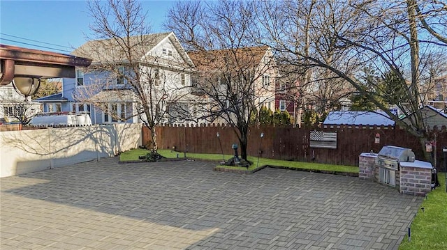 view of patio / terrace with area for grilling, grilling area, and fence